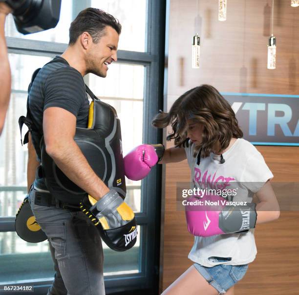 Millie Bobby Brown spars with Mark Wright at "Extra" at Universal Studios Hollywood on October 27, 2017 in Universal City, California.