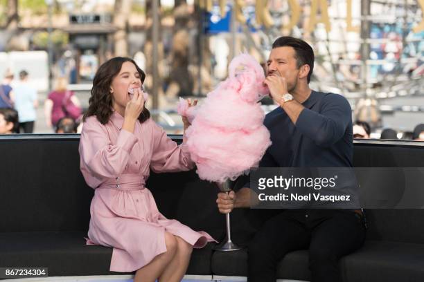 Millie Bobby Brown and Mark Wright eat cotton candy together at "Extra" at Universal Studios Hollywood on October 27, 2017 in Universal City,...