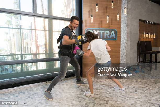 Millie Bobby Brown spars with Mark Wright at "Extra" at Universal Studios Hollywood on October 27, 2017 in Universal City, California.