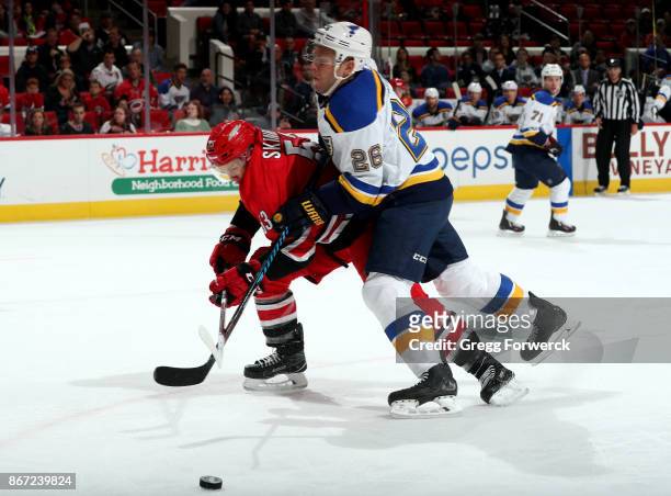 Jeff Skinner of the Carolina Hurricanes has his stick lifted as he is muscled away from the puck by Paul Stastny of the St. Louis Blues during an NHL...