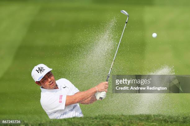 Hideto Tanihara of Japan plays a shot from a bunker on the second hole during the third round of the WGC - HSBC Champions at Sheshan International...