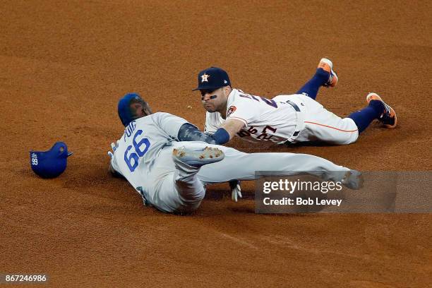 Yasiel Puig of the Los Angeles Dodgers slides in to second and is tagged out by Jose Altuve of the Houston Astros during the fourth inning in game...