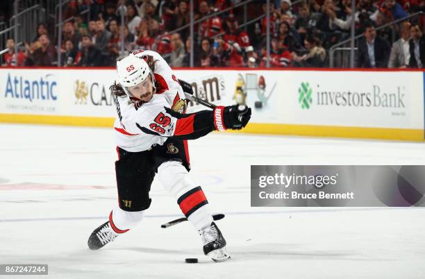 Erik Karlsson of the Ottawa Senators breaks his stick taking a third period shot against the New Jersey Devils at the Prudential Center on October...