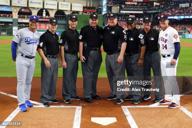 Manager Dave Roberts of the Los Angeles Dodgers and manager A.J. Hinch of the Houston Astros pose for a photo with the umpiring crew prior to Game 3...