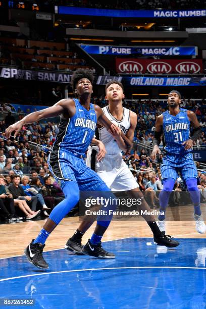 Jonathan Isaac of the Orlando Magic, Kyle Anderson of the San Antonio Spurs, and Terrence Ross of the Orlando Magic await the ball during the game on...