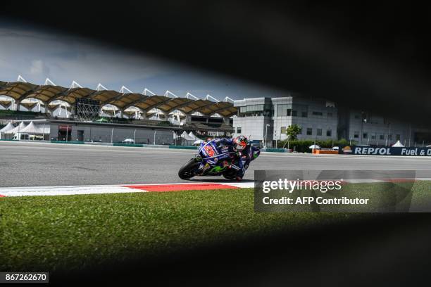 Movistar Yamaha's Spanish rider Maverick Vinales negotiates a corner during the third practice session of the Malaysia MotoGP at the Sepang...