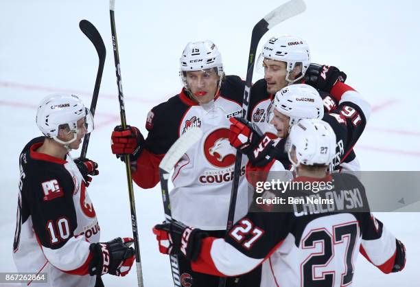 Brogan O'Brien of the Prince George Cougars celebrates teammate Ryan Schoetller's goal against the Vancouver Giants with Josh Curtis, Aaron Boyd and...