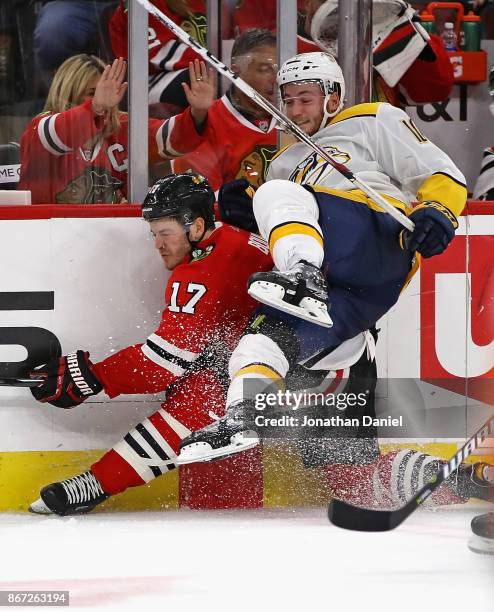 Colton Sissons of the Nashville Predators slams Lance Bouma of the Chicago Blackhawks in the boards at the United Center on October 27, 2017 in...