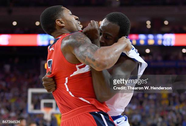 Draymond Green of the Golden State Warriors and Bradley Beal of the Washington Wizards gets tangled up in a fight during the second quarter of their...