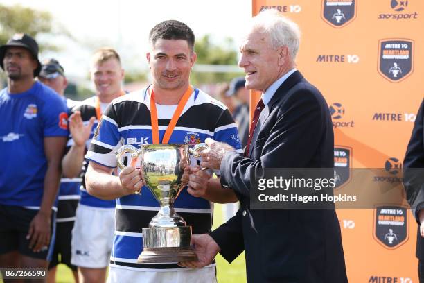 Stan Meads, brother of Colin Meads hands the Colin Meads Cup to captain Cole Baldwin of Wanganui during the Meads Cup Final match between Horowhenua...
