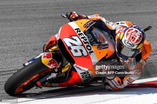 Repsol Honda's Spanish rider Dani Pedrosa takes a corner during the third practice session of the Malaysia MotoGP at the Sepang International circuit...