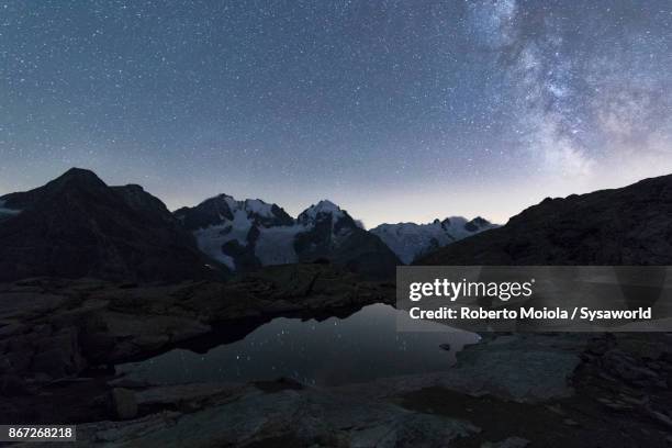 milky way on piz bernina, switzerland - mountain range night stock pictures, royalty-free photos & images