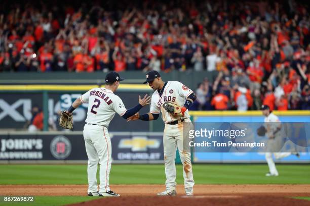 Alex Bregman and Yuli Gurriel of the Houston Astros celebrate after defeating the Los Angeles Dodgers in game three of the 2017 World Series at...