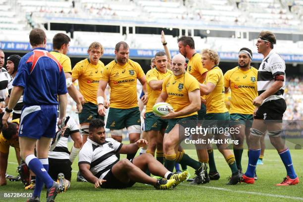Stephen Moore of the Wallabies celebrates with team mates after scoring a try during the match between the Australian Wallabies and the Barbarians at...