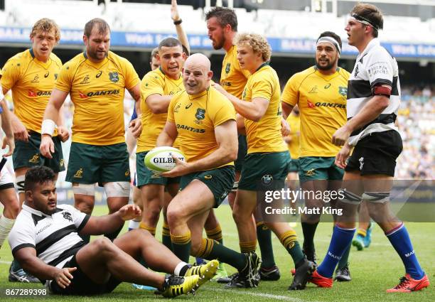 Stephen Moore of the Wallabies celebrates with team mates after scoring a try during the match between the Australian Wallabies and the Barbarians at...