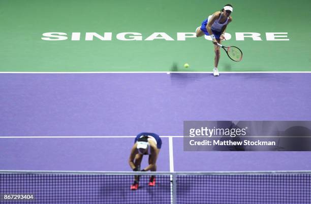 Martina Hingis of Switzerland serves with Chan Yung-Jan of Chinese Taipei in the doubles semi final match against Andrea Hlavackova of Czech Republic...