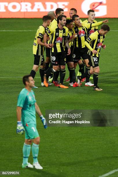 Andrija Kaludjerovic of the Phoenix celebrates with teammates after scoring a goal during the round four A-League match between the Wellington...