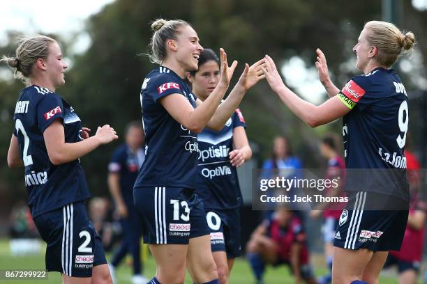 Natasha Dowie of the Victory celebrates a goal with team mates during the round one W-League match between Melbourne Victory and Canberra United at...