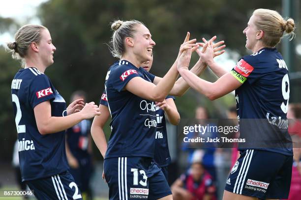 Natasha Dowie of the Victory celebrates a goal with team mates during the round one W-League match between Melbourne Victory and Canberra United at...