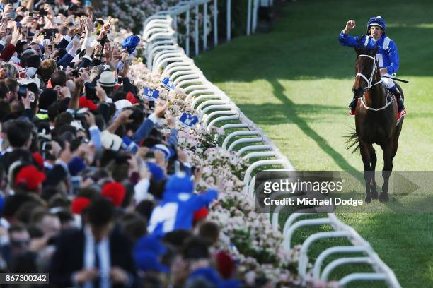 Hugh Bowman celebrates on returning to scale after winning on Winx in race 9 the Ladbrokes Cox Plate during Cox Plate Day at Moonee Valley Racecourse...