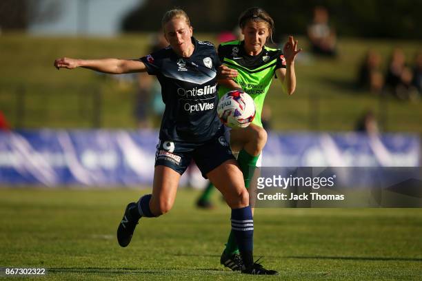 Karly Reostbakken of Canberra and Natasha Dowie of the Victory compete for the ball during the round one W-League match between Melbourne Victory and...