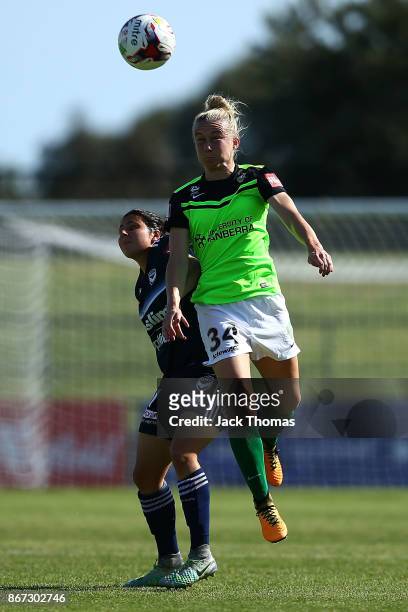 Laura Bassett of Canberra headers the ball during the round one W-League match between Melbourne Victory and Canberra United at Epping Stadium on...