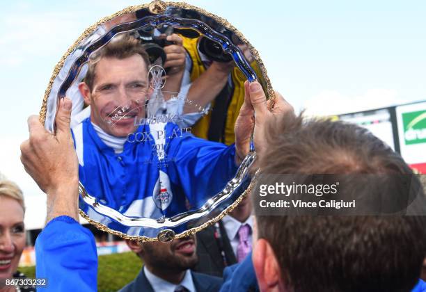 Hugh Bowman poses with the plate after riding Winx to win Race 9, Ladbrokes Cox Plate during Cox Plate Day at Moonee Valley Racecourse on October 28,...