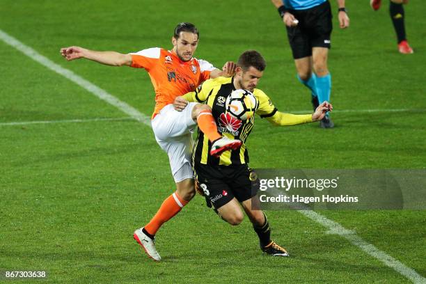 Jack Hingert of Brisbane and Dario Vidosic of the Phoenix compete for the ball during the round four A-League match between the Wellington Phoenix...