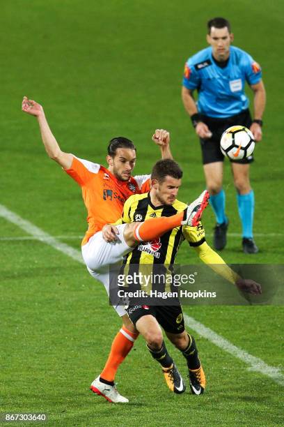 Jack Hingert of Brisbane and Dario Vidosic of the Phoenix compete for the ball during the round four A-League match between the Wellington Phoenix...