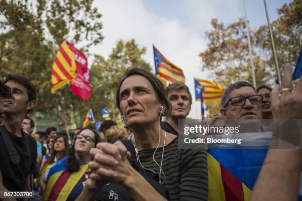 Pro independence supporters react as they wait outside the Catalan parliament for the result of a vote for independence in Barcelona, Spain, on...