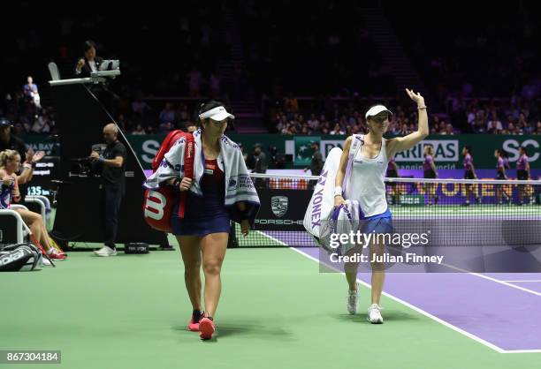 Martina Hingis of Switzerland waves to the crowd in her final tournament with Chan Yung-Jan of Chinese Taipei after their defeat in the doubles semi...