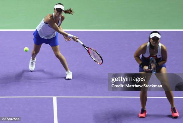 Martina Hingis of Switzerland and Chan Yung-Jan of Chinese Taipei in action in the doubles semi final match against Andrea Hlavackova of Czech...