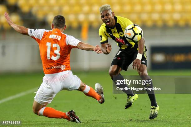 Roy Krishna of the Phoenix is tackled by Jade North of Brisbane during the round four A-League match between the Wellington Phoenix and the Brisbane...