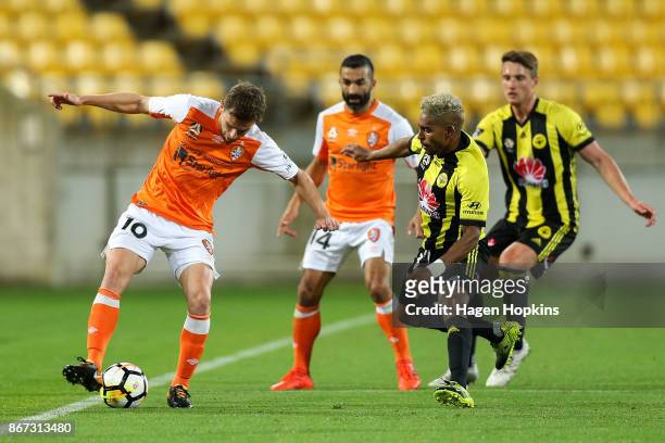 Brett Holman of Brisbane controls the ball under pressure from Roy Krishna of the Phoenix during the round four A-League match between the Wellington...