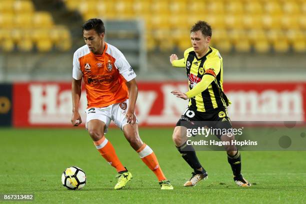 Dane Ingham of Brisbane is challenged by Michael McGlinchey of the Phoenix during the round four A-League match between the Wellington Phoenix and...