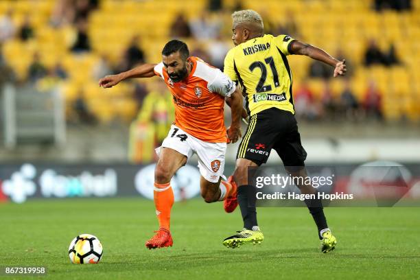 Fahid Ben Khalfallah of Brisbane beats the challenge of Roy Krishna of the Phoenix during the round four A-League match between the Wellington...