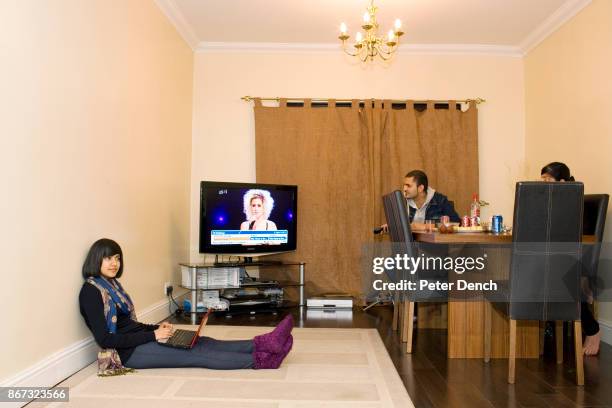 Year old Robin Kullar connects with friends on her laptop via the social networking site Facebook from her home in Southall. Her uncle Blaise and...