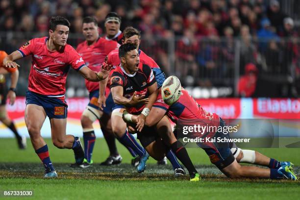 Richie Mo'unga of Canterbury offloads the ball during the Mitre 10 Cup Premiership Final match between Canterbury and Tasman at AMI Stadium on...