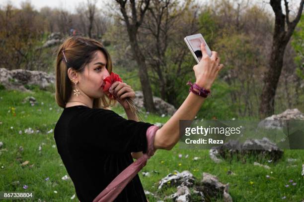 Young woman from Taher family takes a selfie during a picnic. On the first day of spring, following the tradition of new year in all the region,...