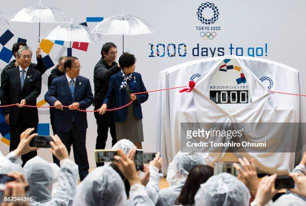 Japanese Olympic Committee President Tsunekazu Takeda, Tokyo 2020 Chief Executive Officer Toshiro Muto, and Tokyo Governor Yuriko Koike, unveil a...