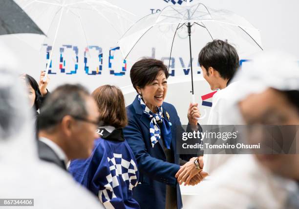 Tokyo Governor Yuriko Koike shakes hands with Olympic athlete Ryosuke Irie at the Tokyo 2020 Olympic 1,000 Days Countdown event on October 28, 2017...