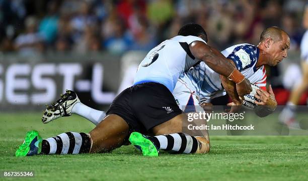 David Marando of the USA is tackled by Tui Kamikamica of Fiji during the 2017 Rugby League World Cup match between Fiji and the United States on...