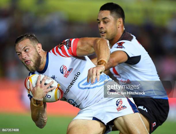 Ryan Burroughs of the USA is tackled by Jarryd Hayne of Fiji during the 2017 Rugby League World Cup match between Fiji and the United States on...
