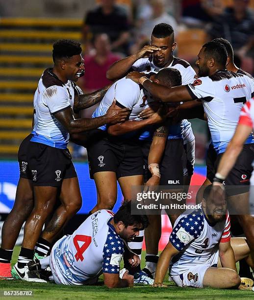 Kane Evans of Fiji suffers an arm injury after scoring a try during the 2017 Rugby League World Cup match between Fiji and the United States on...