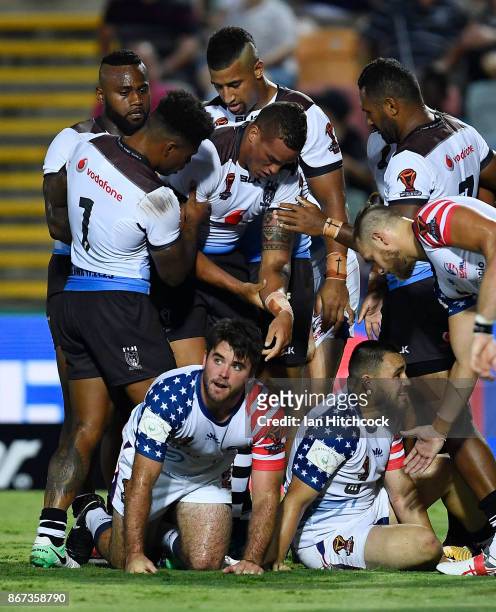 Kane Evans of Fiji suffers an arm injury after scoring a try during the 2017 Rugby League World Cup match between Fiji and the United States on...