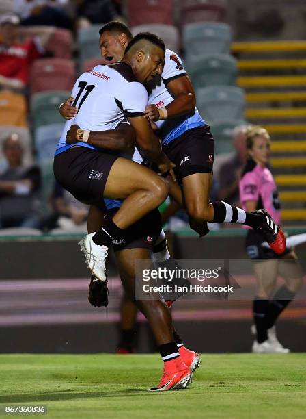 Akuila Uate of Fiji celebrates after scoring a try with Viliame Kikau and Marcelo Montoya of Fiji during the 2017 Rugby League World Cup match...