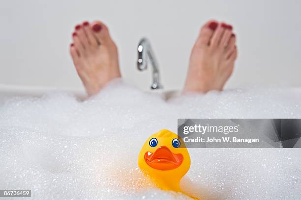 duck and feet in bath - pato de juguete fotografías e imágenes de stock