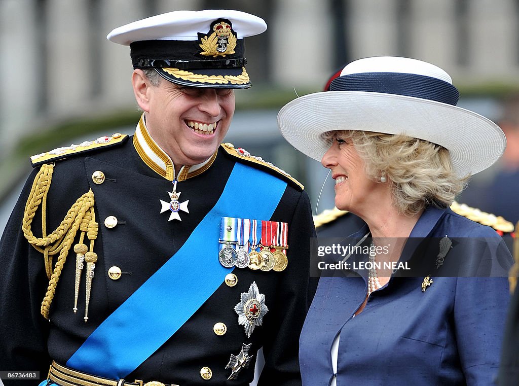 Britain's Prince Andrew (L) talks with C