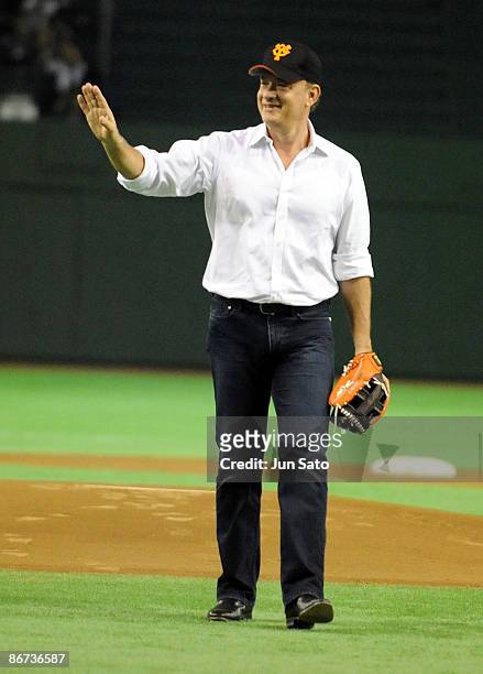 Actor Tom Hanks gestures during the ceremonial first pitch prior to the professional baseball match between Yomiuri Giants and Chunichi Dragons at...