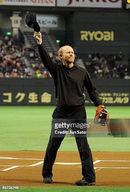 Director Ron Howard gestures to the crowd during the ceremonial first pitch prior to the professional baseball match between Yomiuri Giants and...